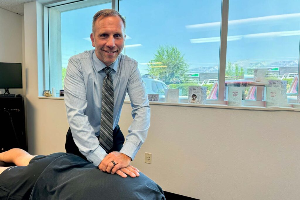 Dr Scott Graziosa giving his patient a back pain treatment