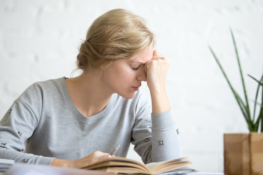 a woman suffering from vertigo while reading a book